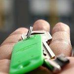 hand holding key to home