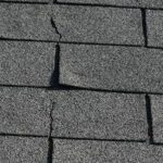 damaged shingles with cracks and peeling