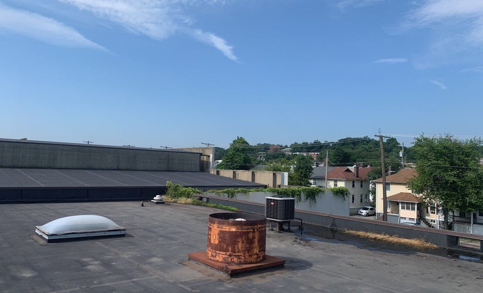 Roof leak with standing water puddle on flat roof