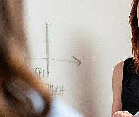 Woman by whiteboard diagraming vent pipe