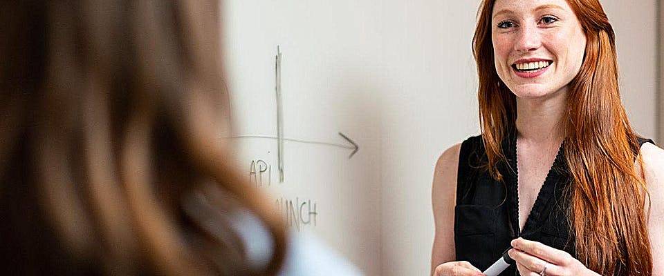 Woman by whiteboard diagraming vent pipe