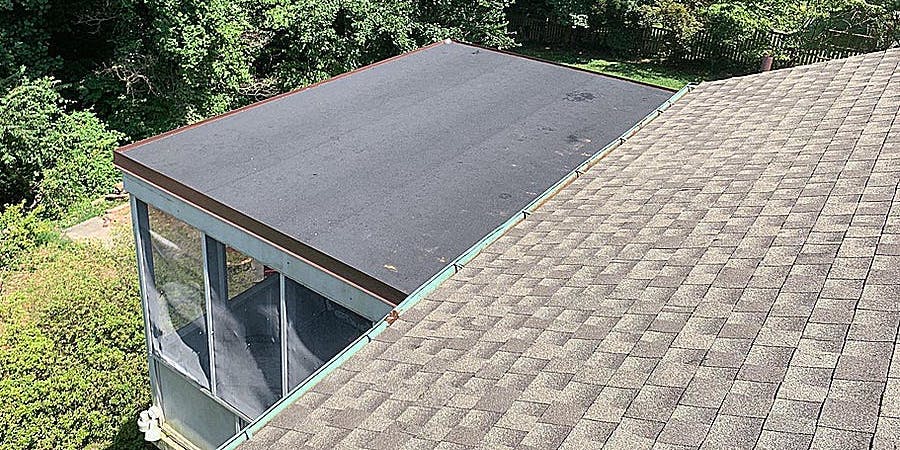 House with an attached flat roof